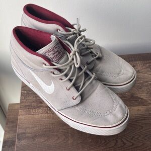 Nike SB Zoom Stefan Janoski Mid in the Wolf Grey/White-Team Red colorway.
